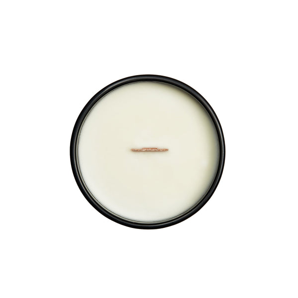 The top view of the soy candle (wax white), with a view of the wood wick.